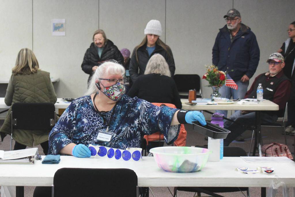 K-Beach Precinct Chair Kathy Carson assists voters at the Soldotna Regional Sports Complex on Tuesday, Nov. 8, 2022 in Soldotna, Alaska. (Ashlyn OHara/Peninsula Clarion)
