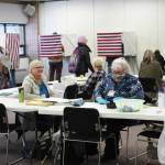 K-Beach Precinct Chair Kathy Carson (right) and Carol Louthan (left) assist voters at the Soldotna Regional Sports Complex on Tuesday, Nov. 8, 2022 in Soldotna, Alaska. (Ashlyn OHara/Peninsula Clarion)