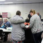Poll worker Harmony Bolden (right) helps a voter cast their ballot at the Soldotna Regional Sports Complex on Tuesday, Nov. 8, 2022 in Soldotna, Alaska. (Ashlyn OHara/Peninsula Clarion)
