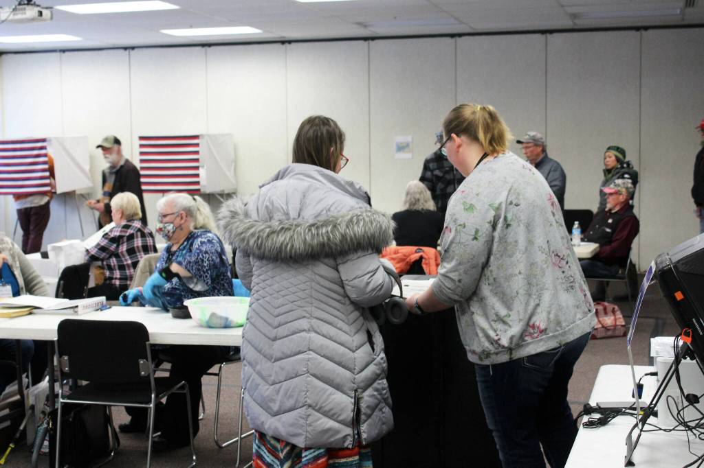 Poll worker Harmony Bolden (right) helps a voter cast their ballot at the Soldotna Regional Sports Complex on Tuesday, Nov. 8, 2022 in Soldotna, Alaska. (Ashlyn OHara/Peninsula Clarion)