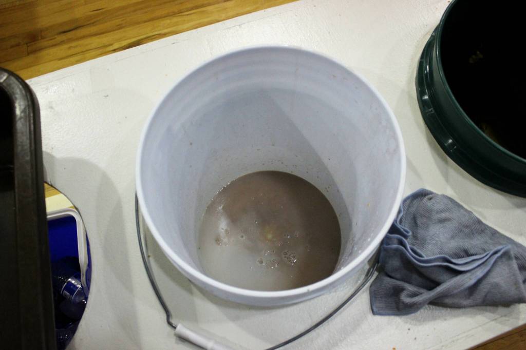 A bucket collects chocolate milk and other liquids in the cafeteria at Sterling Elementary School on Thursday, Nov. 10, 2022 in Sterling, Alaska. (Ashlyn OHara/Peninsula Clarion)