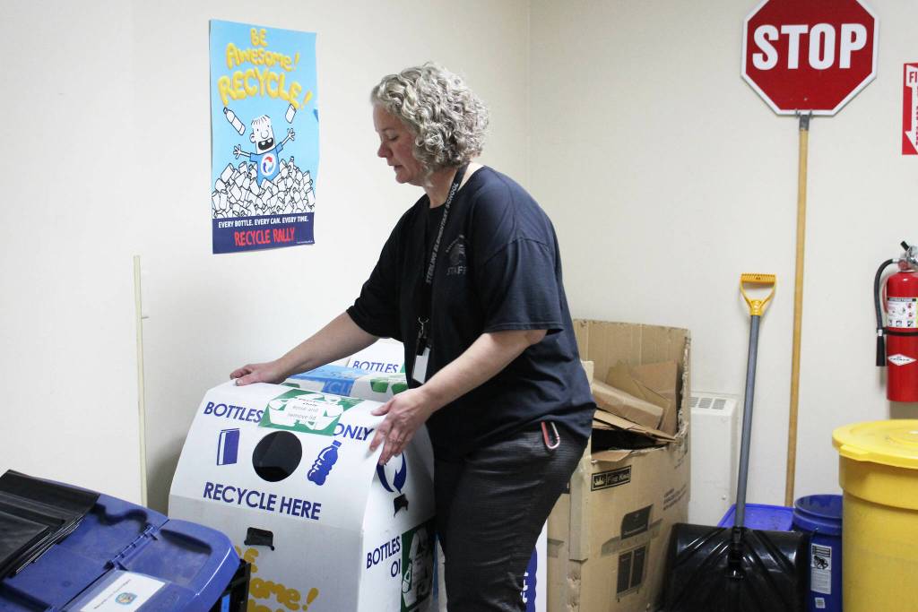 Principal Denise Kelly adjusts recycling receptacles at Sterling Elementary School on Thursday, Nov. 10, 2022, in Sterling, Alaska. (Ashlyn OHara/Peninsula Clarion)