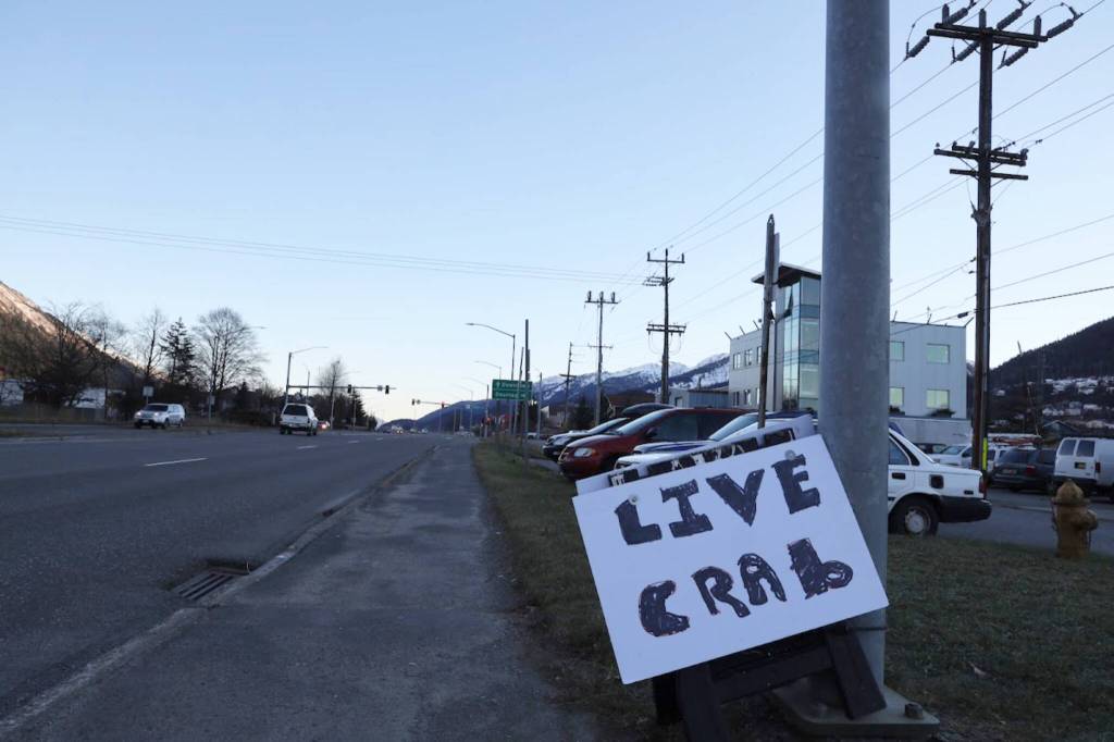 A foam sign with the words live crab written with a black marker sits at the entrance of Aurora Harbor along Egan Drive Monday afternoon. Charlie Blattner, a Juneau-based Dungeness crab fisherman, was berthed at Aurora Harbor selling live Dungeness crabs he caught in the past few days around the Juneau area. (Clarise Larson / Juneau Empire)