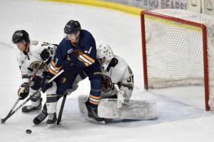 Kenai River Brown Bears defenseman Joe Manning and Springfield (Illinois) Jr. Blues forward Hadley Hudak battle in front of Bears goalie Bryant Marks on Sunday, Nov. 13, 2022, at the Soldotna Regional Sports Complex in Soldotna, Alaska. (Photo by Jeff Helminiak/Peninsula Clarion)