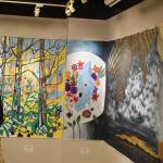 An attendee of the opening reception for the Mural 2022 exhibition views this years mural at the Kenai Art Center in Kenai, Alaska, on Thursday, Nov. 10, 2022. (Jake Dye/Peninsula Clarion)