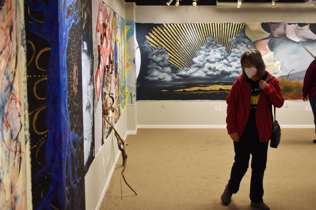 Eileen Bryson views the mural during the opening reception for Mural 2022 at the Kenai Art Center in Kenai, Alaska, on Thursday, Nov. 10, 2022. (Jake Dye/Peninsula Clarion)