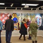 Attendees of the opening reception for the Mural 2022 Exhibition view this years mural at the Kenai Art Center in Kenai, Alaska, on Thursday, Nov. 10, 2022. (Jake Dye/Peninsula Clarion)