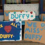 Signs in honor of Duffy Murnane were available for people to hold while retracing her last known steps during the memorial walk on Saturday, Oct. 17, 2021. (Photo by Sarah Knapp/Homer News)