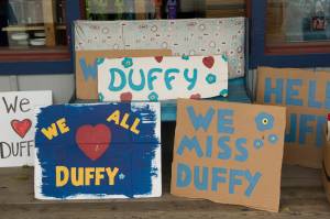 Signs in honor of Duffy Murnane were available for people to hold while retracing her last known steps during the memorial walk on Saturday, Oct. 17, 2021. (Photo by Sarah Knapp/Homer News)