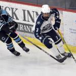 Soldotnas Andrew Arthur brings the puck out from behind the net under pressure from Chugiaks Shayden Davis on Friday, Nov. 18, 2022, at the Soldotna Regional Sports Complex in Soldotna, Alaska. (Photo by Jeff Helminiak/Peninsula Clarion)