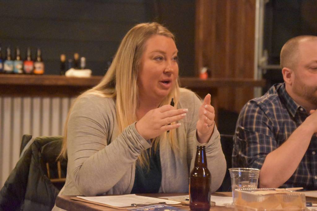 Jill Schaefer, one of the sharks, questions a contestant during the Spark Soldotna Shark Tank Event on Friday, Nov. 18, 2022, at The Lone Moose Lodge in Soldotna, Alaska. (Jake Dye/Peninsula Clarion)