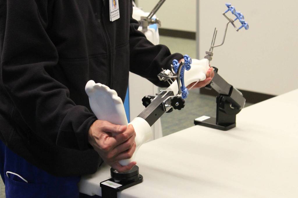 Dr. Michael Reyes manipulates a model leg during a demonstration of ROSA at Central Peninsula Hospital on Monday, Nov. 21, 2022, in Soldotna, Alaska. (Ashlyn OHara/Peninsula Clarion)