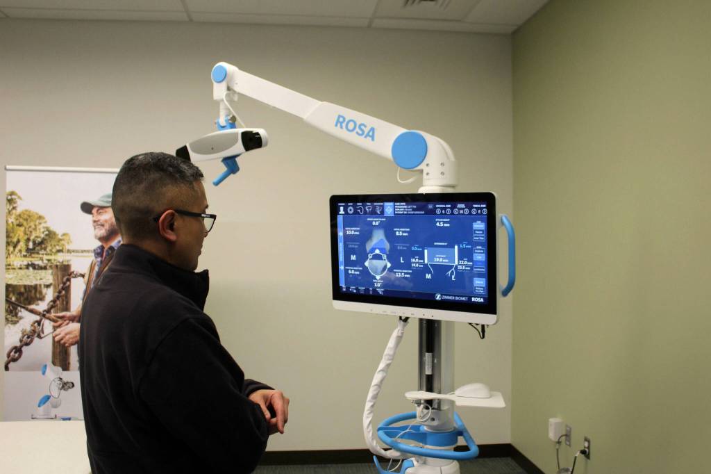 Dr. Michael Reyes reads data off of ROSA during a demonstration of a knee replacement surgery at Central Peninsula Hospital on Monday, Nov. 21, 2022, in Soldotna, Alaska. (Ashlyn OHara/Peninsula Clarion)