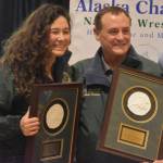 Tela ODonnell-Bacher and Neldon Gardner hold their plaques after being inducted into the National Wrestling Hall of Fame following a duel wrestling meet on Tuesday, Nov. 22, 2022, at Soldotna High School in Soldotna, Alaska. (Jake Dye/Peninsula Clarion)