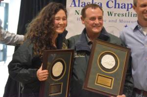 Tela ODonnell-Bacher and Neldon Gardner hold their plaques after being inducted into the National Wrestling Hall of Fame following a duel wrestling meet on Tuesday, Nov. 22, 2022, at Soldotna High School in Soldotna, Alaska. (Jake Dye/Peninsula Clarion)