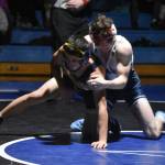 Soldotnas Zeek Miller holds Homers Paul Minke during a duel wrestling meet on Tuesday, Nov. 22, 2022, at Soldotna High School in Soldotna, Alaska. (Jake Dye/Peninsula Clarion)