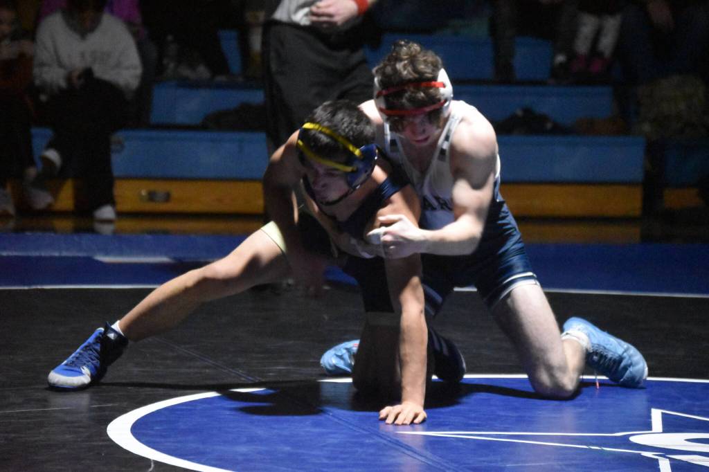 Soldotnas Zeek Miller holds Homers Paul Minke during a duel wrestling meet on Tuesday, Nov. 22, 2022, at Soldotna High School in Soldotna, Alaska. (Jake Dye/Peninsula Clarion)