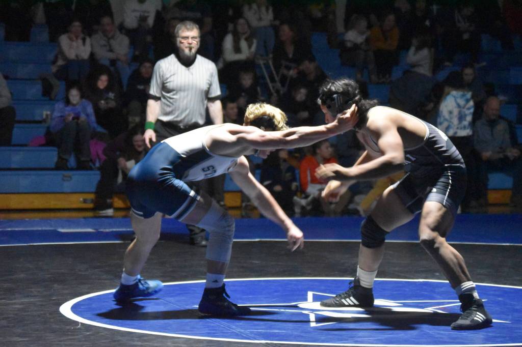Soldotnas Edger Land swings at Nikiskis Jakeup Martin during a duel wrestling meet on Tuesday, Nov. 22, 2022, at Soldotna High School in Soldotna, Alaska. (Jake Dye/Peninsula Clarion)