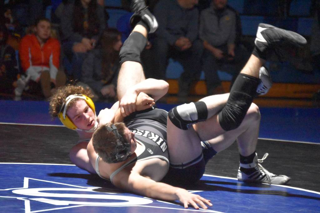 Soldotnas Hunter Richardson holds Nikiskis Tim Goodnight during a duel wrestling meet on Tuesday, Nov. 22, 2022, at Soldotna High School in Soldotna, Alaska. (Jake Dye/Peninsula Clarion)