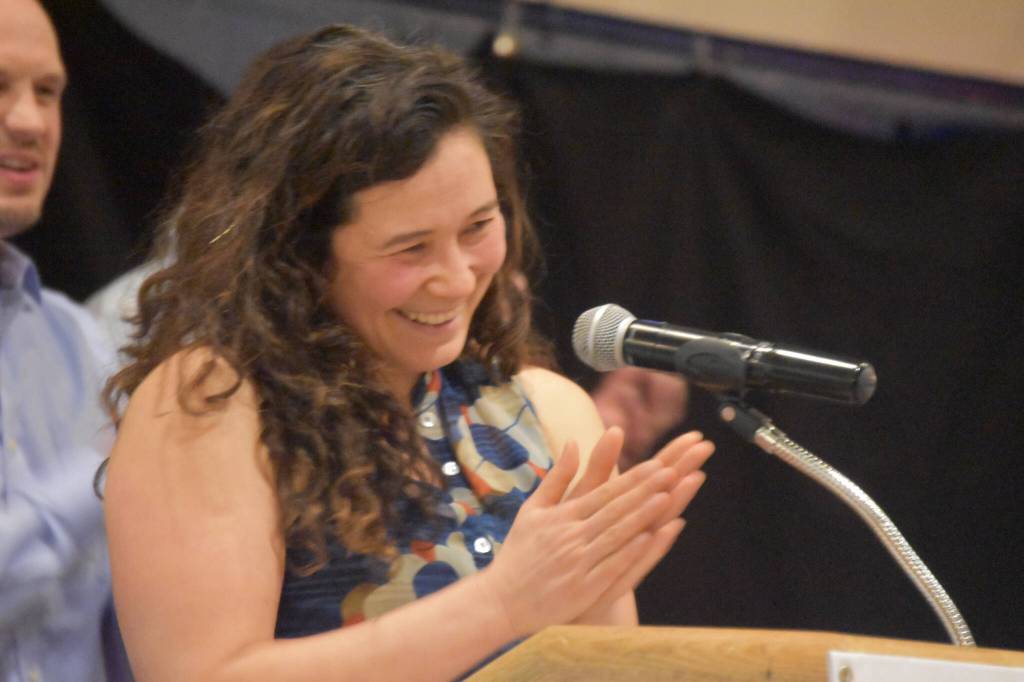 Tela ODonnell-Bacher leads applause for her mother while being inducted to the National Wrestling Hall of Fame following the duel wrestling meet on Tuesday, Nov. 22, 2022, at Soldotna High School in Soldotna, Alaska. (Jake Dye/Peninsula Clarion)