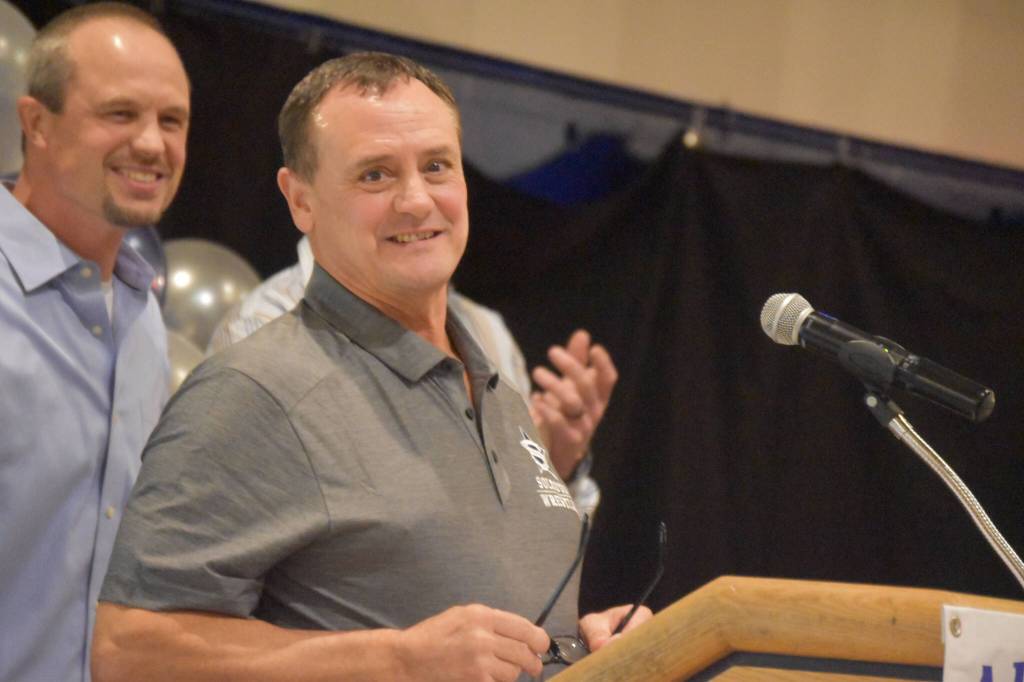 Neldon Gardner speaks while being inducted to the National Wrestling Hall of Fame following the duel wrestling meet on Tuesday, Nov. 22, 2022, at Soldotna High School in Soldotna, Alaska. (Jake Dye/Peninsula Clarion)