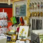 Artwork depicting animals, mushrooms and nature by Nethes Brush are seen, ready to be sold, ahead of the Kenai Arts & Crafts Fair during early set up at Kenai Central High School in Kenai, Alaska, on Wednesday, Nov. 23, 2022. (Jake Dye/Peninsula Clarion)