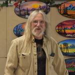 David Hartman, of David Hartman Signs, is seen with his product on display ahead of the Kenai Arts & Crafts Fair during early set up at Kenai Central High School in Kenai, Alaska, on Wednesday, Nov. 23, 2022. (Jake Dye/Peninsula Clarion)