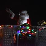 Santa Claus waves to the crowd during the Electric Light Parade, part of Christmas Comes to Kenai festivities at the Kenai Chamber of Commerce and Visitor Center in Kenai, Alaska, on Friday, Nov. 25, 2022. (Jake Dye/Peninsula Clarion)