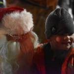Santa Claus is seen with a child at Christmas Comes to Kenai festivities at the Kenai Chamber of Commerce/Visitor Center in Kenai, Alaska on Friday, Nov. 25, 2022. (Jake Dye/Peninsula Clarion)