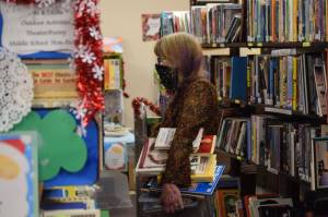 Camille Botello / Peninsula Clarion file
Junetta Delong browses the shelves at the Soldotna Library Friends book and art sale at the Soldotna Public Library on Saturday, Dec. 4, 2021.