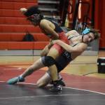 Nikiskis Niles Broussard throws Kenais Delen Byrd during a dual meet on Tuesday, Nov. 29, 2022, at Kenai Central High School in Kenai, Alaska. (Jake Dye/Peninsula Clarion)