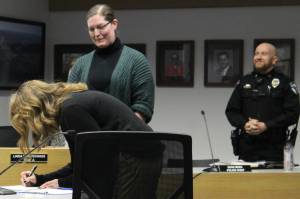 Johni Blankenship signs her name after being sworn in as Soldotna City Clerk at a city council meeting on Wednesday, Nov. 30, 2022, in Soldotna, Alaska. (Ashlyn OHara/Peninsula Clarion)