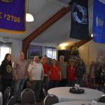 Members of the Soldotna Elks Lodge #2706, including Exalted Ruler Robert Dixon and Secretary Shannon Woodford (third and fifth from the left) stand with purchased toys and clothes for donation to local children at the lodge in Soldotna, Alaska, on Friday, Dec. 2, 2022. (Jake Dye/Peninsula Clarion)