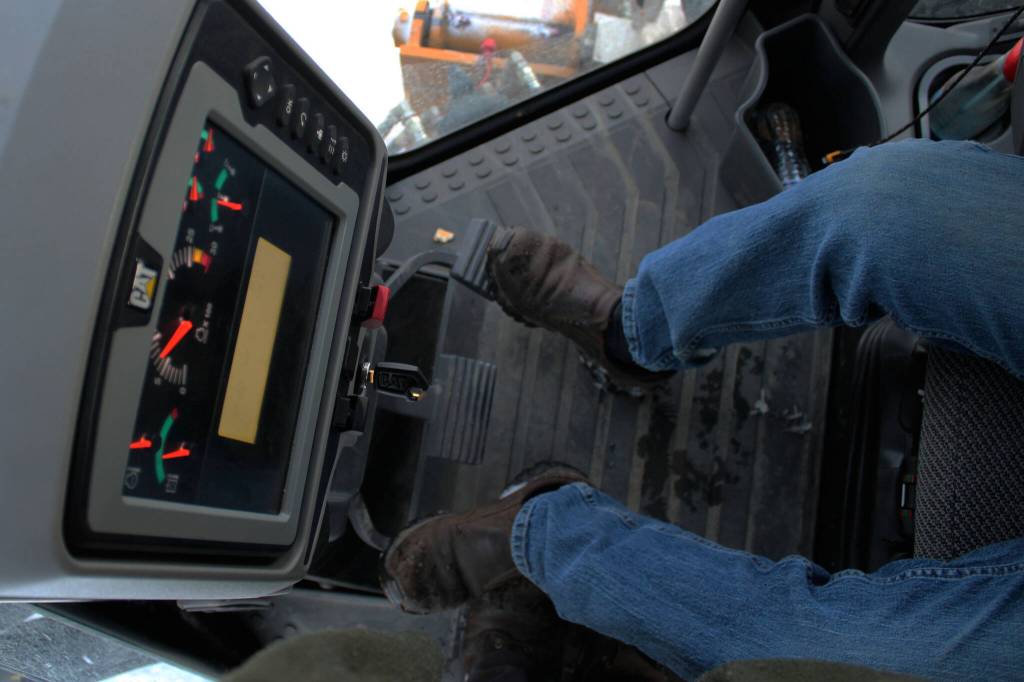 Kenai City Streets foreman Curt Wagoner operates a city grader on Wednesday, Dec. 7, 2022 in Kenai, Alaska. (Ashlyn OHara/Peninsula Clarion)
