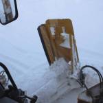 A City of Kenai grader collects snow along a roadway on Wednesday, Dec. 7, 2022, in Kenai, Alaska. (Ashlyn OHara/Peninsula Clarion)