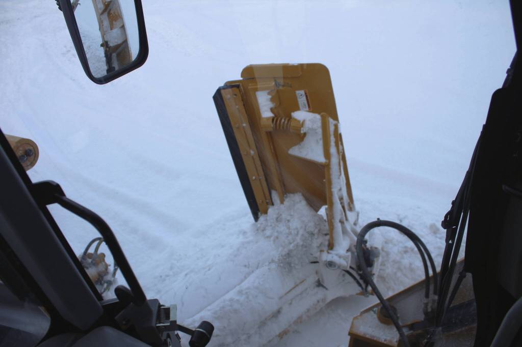 A City of Kenai grader collects snow along a roadway on Wednesday, Dec. 7, 2022, in Kenai, Alaska. (Ashlyn OHara/Peninsula Clarion)