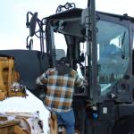 Kenai City Streets foreman Curt Wagoner climbs inside of a city grader on Wednesday, Dec. 7, 2022, in Kenai, Alaska. (Ashlyn OHara/Peninsula Clarion)