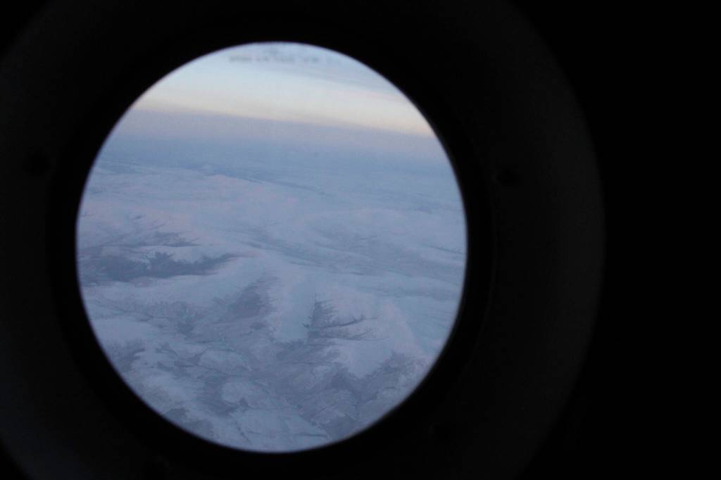 The frozen tundra of northern Alaska is seen out a window of an Alaska National Guard cargo plane en route to Nuiqsut, Alaska, on Tuesday, Nov. 29, 2022. Operation Santa Claus, the Alaska National Guards outreach program, attempts to bring Santa and Mrs. Claus and gifts to children in two or three Alaska Native villages each year, including Nuiqsut in 2022. (AP Photo/Mark Thiessen)