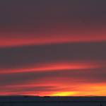 This photo, taken just after noon on Tuesday, Nov. 29, 2022, shows the run just rising above the horizon in Nuiqsut, Alaska. Operation Santa Claus, the Alaska National Guards outreach program, attempts to bring Santa and Mrs. Claus and gifts to children in two or three Alaska Native villages each year, including Nuiqsut in 2022. (AP Photo/Mark Thiessen)