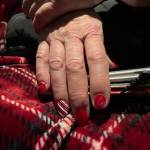 This photo shows Mrs. Claus holiday-themed fingernails during a plane ride trip to Nuiqsut, Alaska, on Tuesday, Nov. 29, 2022. Operation Santa Claus, the Alaska National Guards outreach program, attempts to bring Santa and Mrs. Claus and gifts to children in two or three Alaska Native villages each year. (AP Photo/Mark Thiessen)