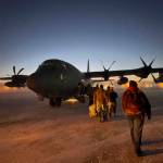 Helpers in the Alaska National Guards Operation Santa Claus board a cargo plane at Joint Base Elmendorf-Anchorage on Tuesday, Nov. 29, 2022, for a flight to Nuiqsut, Alaska. The guards outreach program attempts to bring Santa and Mrs. Claus and gifts to children in two or three Alaska Native villages each year. (AP Photo/Mark Thiessen)
