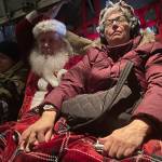 Santa and Mrs Claus rest on the plane trip to Nuiqsut, Alaska, on Tuesday, Nov. 29, 2022. Operation Santa Claus, the Alaska National Guards outreach program, attempts to bring Santa and Mrs. Claus and gifts to children in two or three Alaska Native villages each year. (AP Photo/Mark Thiessen)