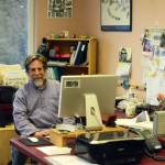 Michael Armstrong poses at his desk in February 2015 at the Homer News in Homer, Alaska. (Photo by McKibben Jackinsky)