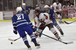 Kenai Central's Logan Mese takes on Palmer's Brandon Horacek on Friday, Dec. 9, 2022, at the Kenai Multi-Purpose Facility in Kenai, Alaska. (Photo by Jeff Helminiak/Peninsula Clarion)