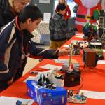 A potential buyer checks out the Lego Fender Stratocaster during Bark, Block and Bowl on Saturday, Dec. 10, 2022, at the Kenai Peninsula Food Bank in Soldotna, Alaska. (Jake Dye/Peninsula Clarion)