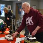 Greg Meyer shows off the Lego sets he built as they are put on auction during Bark, Block and Bowl on Saturday, Dec. 10, 2022, at the Kenai Peninsula Food Bank in Soldotna, Alaska. (Jake Dye/Peninsula Clarion)