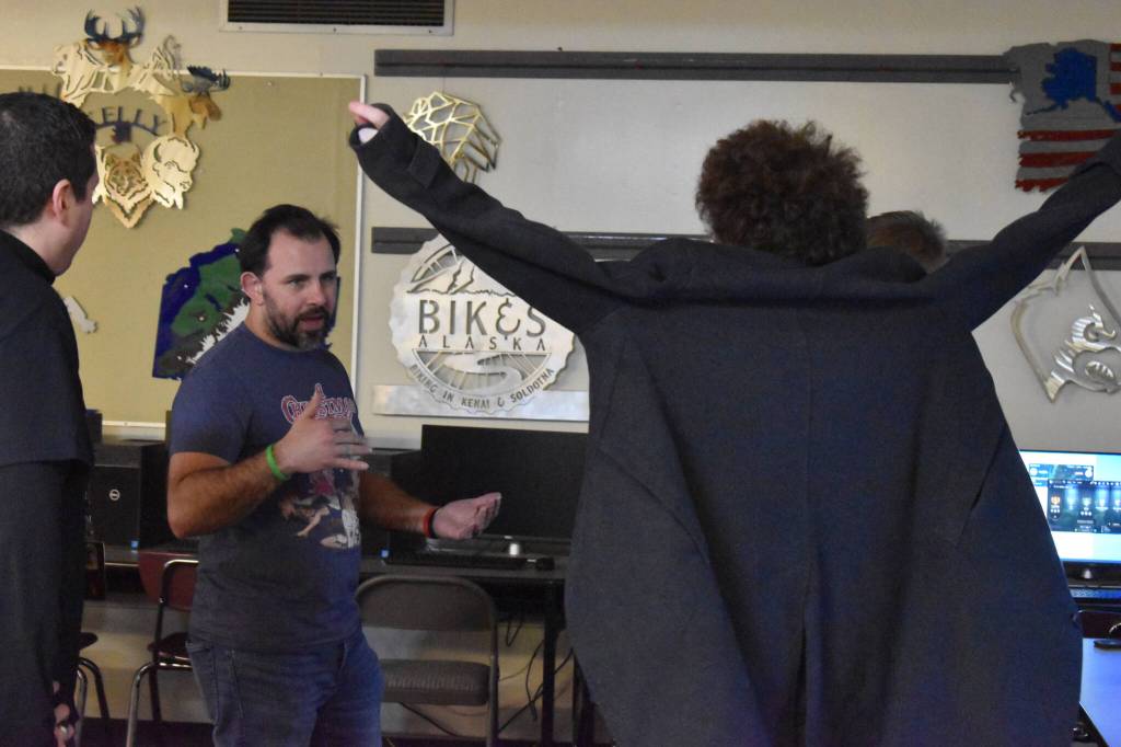 Coach Shane Lopez speaks to Silas Thibodeau ahead of the League of Legends ASAA State Championship Match on Tuesday, Dec. 13, 2022 at Kenai Central High School in Kenai, Alaska. (Jake Dye/Peninsula Clarion)