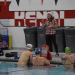 Angie Brennan directs swimmers as they prepare for a workout set during a Top of the World Swimming practice on Wednesday, Dec. 14, 2022, at Kenai Central High School in Kenai, Alaska. (Jake Dye/Peninsula Clarion)