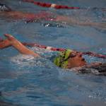 Carolann Barum swims the backstroke during a Top of the World Swimming practice on Wednesday, Dec. 14, 2022, at Kenai Central High School in Kenai, Alaska. (Jake Dye/Peninsula Clarion)