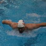 Lucas Petersen swims the butterfly during a Top of the World Swimming practice on Wednesday, Dec. 14, 2022, at Kenai Central High School in Kenai, Alaska. (Jake Dye/Peninsula Clarion)